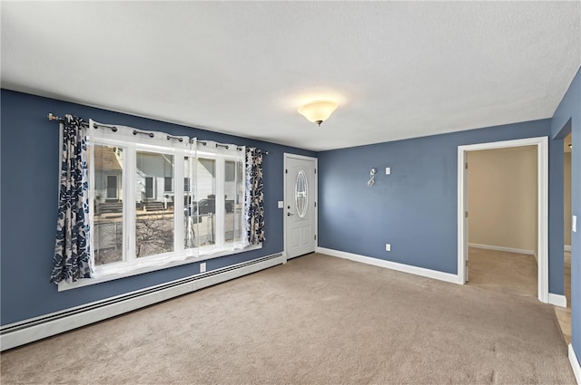 unfurnished room featuring baseboards, carpet, and a baseboard radiator