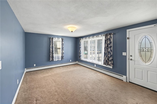 carpeted entryway with a baseboard heating unit and a textured ceiling