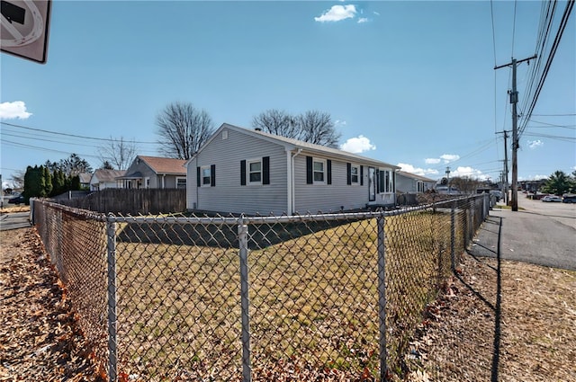 view of side of home featuring fence