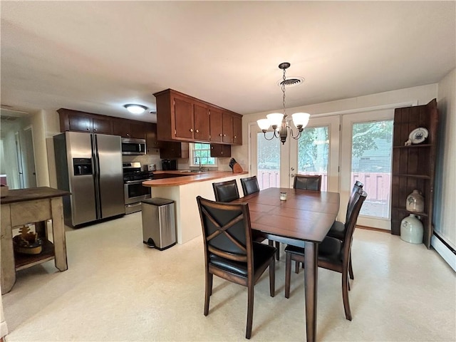 dining area featuring an inviting chandelier, light floors, and visible vents