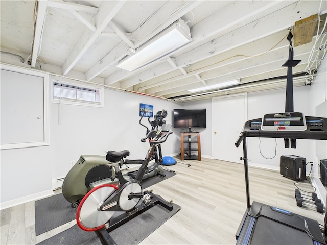 workout room with wood finished floors and baseboards