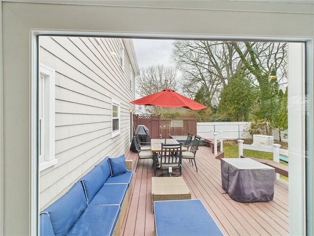 wooden terrace with outdoor dining space, an outdoor living space, and fence