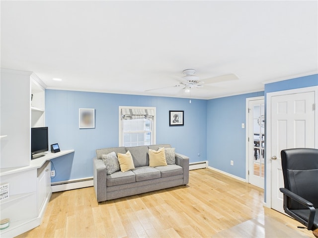 living room featuring crown molding, a ceiling fan, light wood-type flooring, and a baseboard radiator