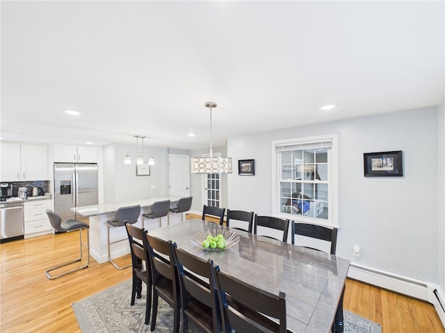 dining area featuring baseboard heating, recessed lighting, and light wood-type flooring