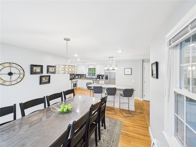 dining area with recessed lighting, baseboards, and light wood-style floors