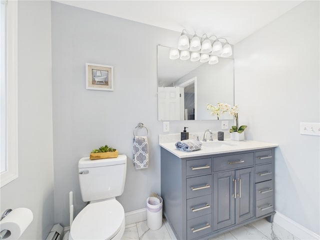 bathroom with baseboards, toilet, marble finish floor, and vanity