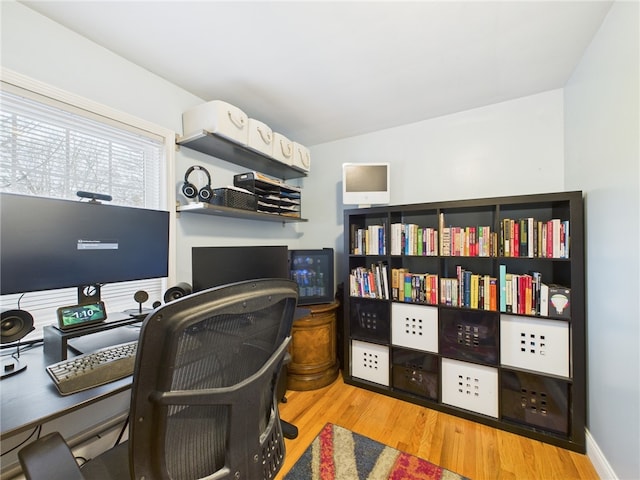 home office featuring baseboards and wood finished floors