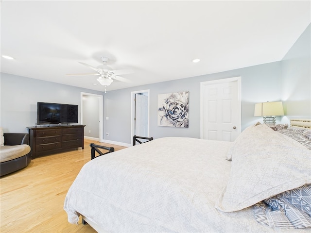 bedroom featuring a ceiling fan, wood finished floors, and baseboards