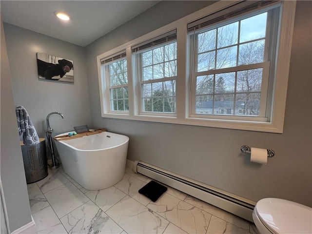 bathroom with a baseboard heating unit, toilet, recessed lighting, a soaking tub, and marble finish floor