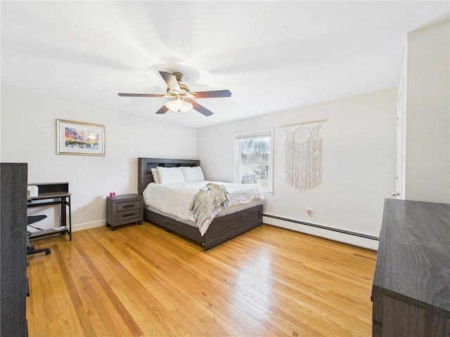 bedroom with light wood finished floors, baseboards, a baseboard heating unit, and a ceiling fan