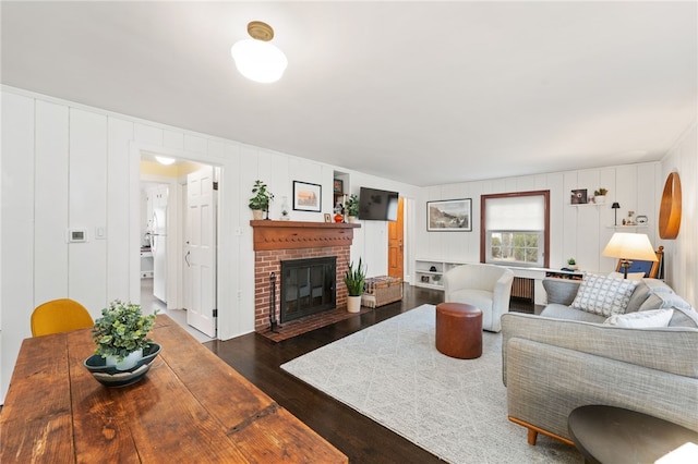 living room featuring wood finished floors and a fireplace