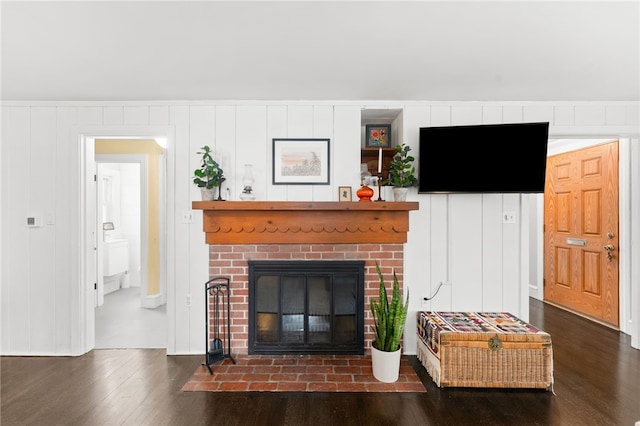 living room with a fireplace and wood finished floors