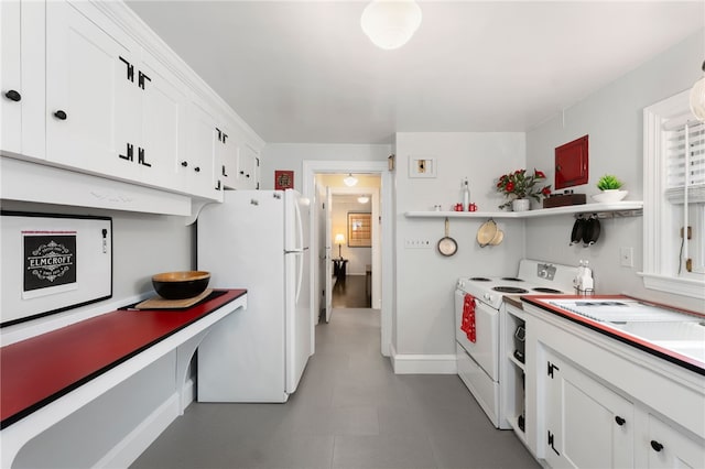 kitchen with open shelves, white appliances, white cabinets, light countertops, and baseboards