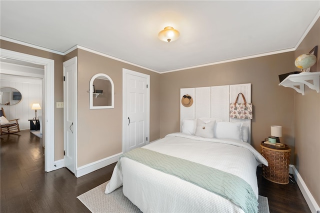 bedroom with baseboards, ornamental molding, and dark wood-style flooring