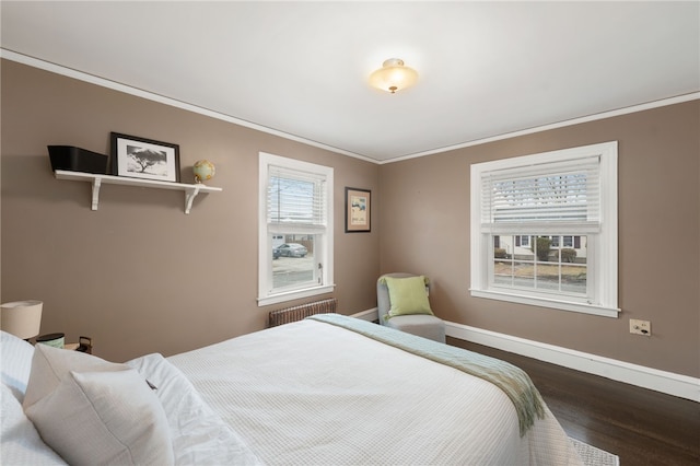 bedroom featuring baseboards, radiator, crown molding, and dark wood-type flooring