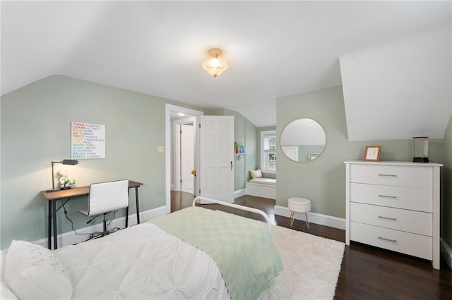 bedroom featuring baseboards, lofted ceiling, and dark wood-style floors