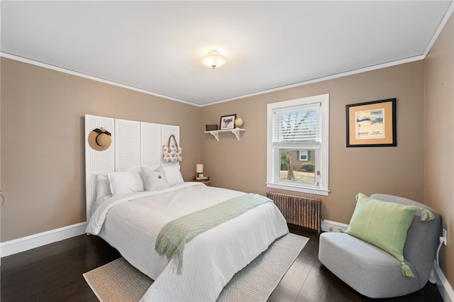 bedroom featuring wood finished floors, radiator heating unit, and crown molding