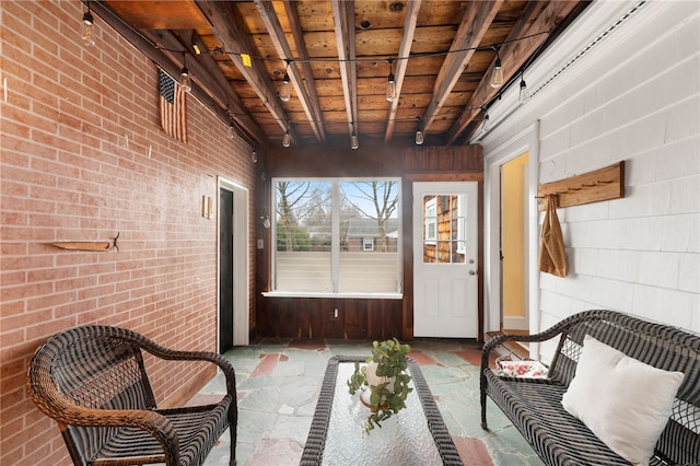 sunroom / solarium featuring beamed ceiling