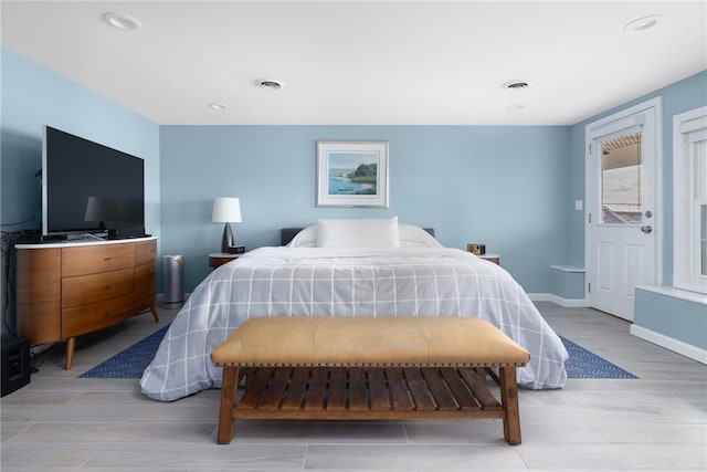 bedroom with visible vents, recessed lighting, light wood-type flooring, and baseboards