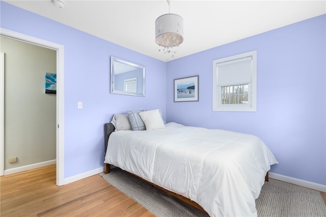 bedroom featuring wood finished floors and baseboards