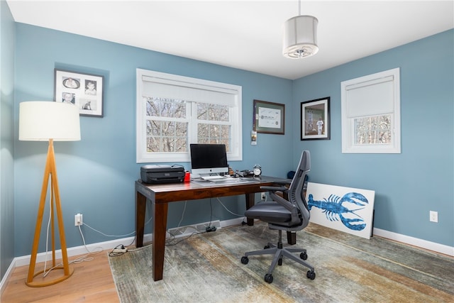 home office with a wealth of natural light, baseboards, and wood finished floors