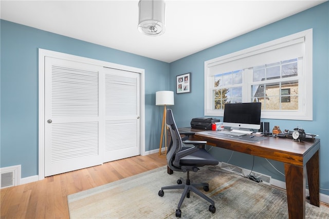 office with visible vents, baseboards, and wood finished floors