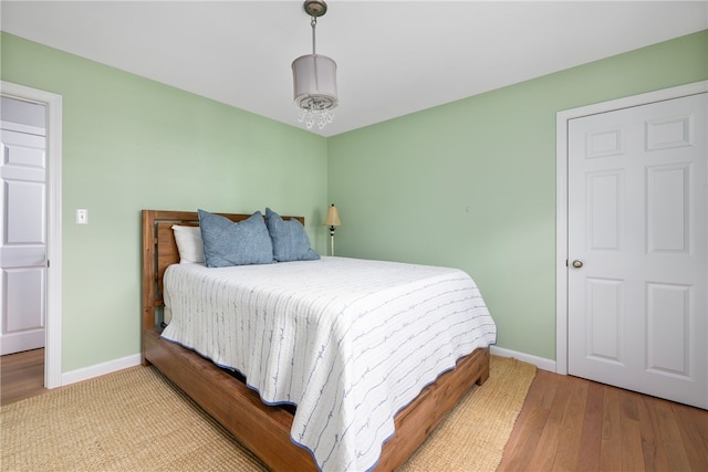 bedroom featuring baseboards and wood finished floors