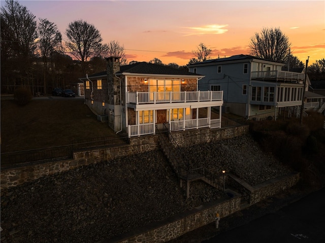 back of property featuring a balcony