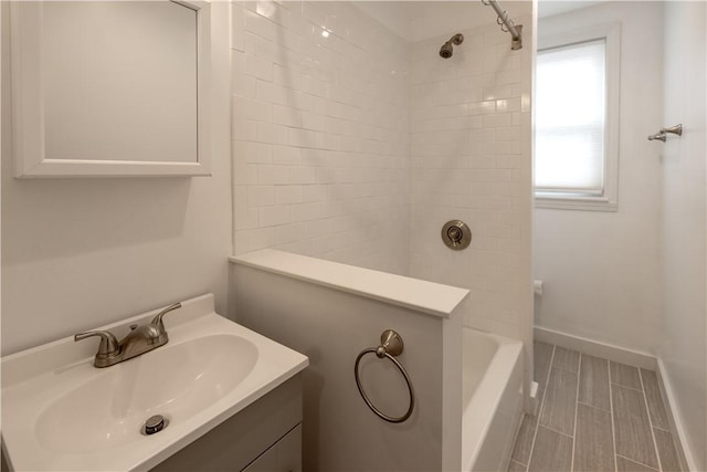 full bathroom with vanity, shower / bathing tub combination, and baseboards