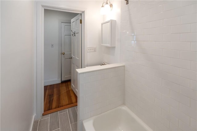 bathroom with baseboards and wood finished floors