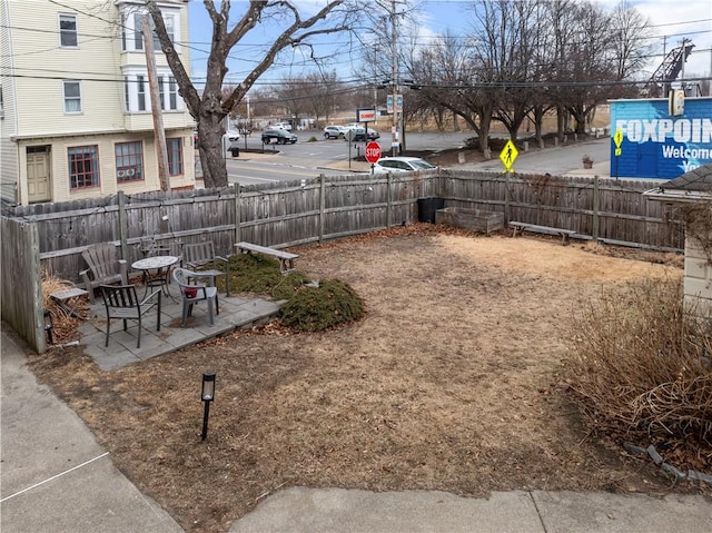 view of yard featuring a patio and fence