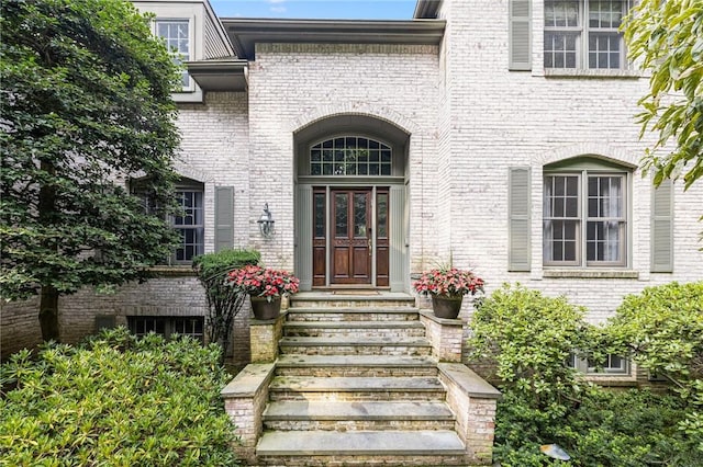 entrance to property with brick siding