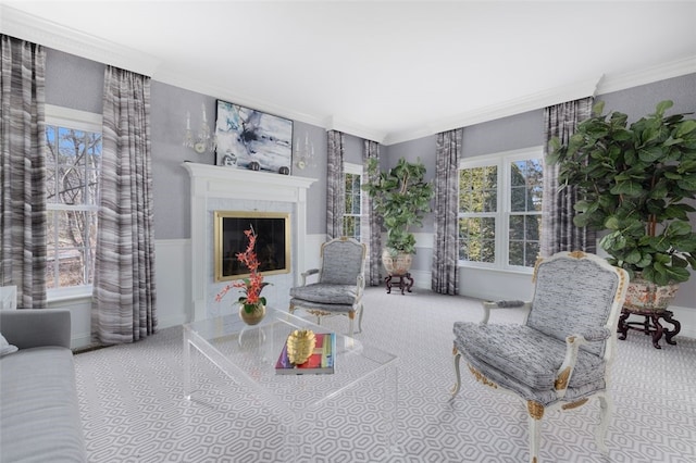 living room with a glass covered fireplace and crown molding