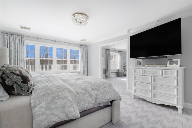 bedroom with visible vents, baseboards, and ornamental molding