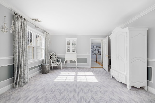 unfurnished room featuring light wood finished floors, visible vents, and crown molding