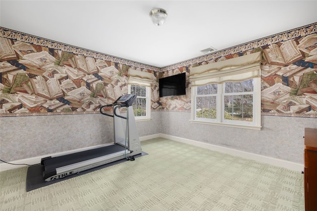 exercise room featuring baseboards and wallpapered walls