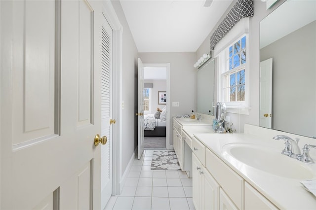 ensuite bathroom with vanity, tile patterned floors, ensuite bathroom, and a wealth of natural light