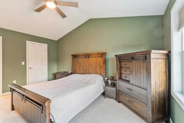 bedroom featuring light carpet, baseboards, a ceiling fan, and lofted ceiling