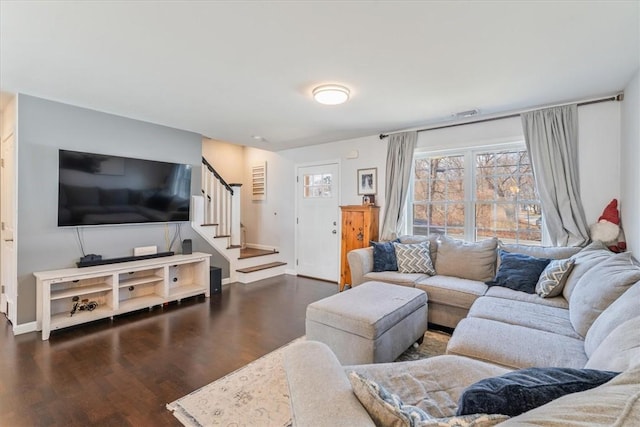 living room featuring dark wood finished floors, stairway, and baseboards