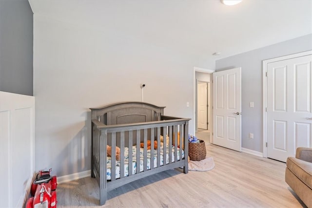 bedroom featuring wood finished floors and baseboards