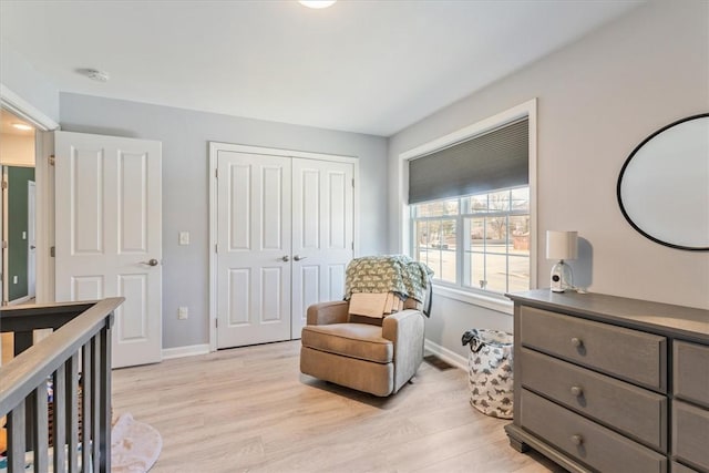 bedroom with a closet, visible vents, light wood-type flooring, and baseboards