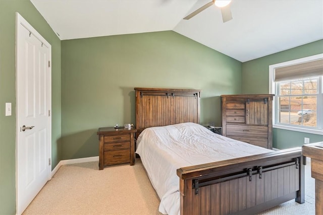 bedroom featuring ceiling fan, lofted ceiling, baseboards, and light carpet