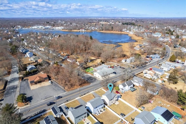 drone / aerial view featuring a residential view and a water view