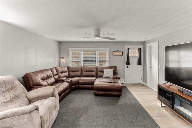 living room with light wood-type flooring and a ceiling fan