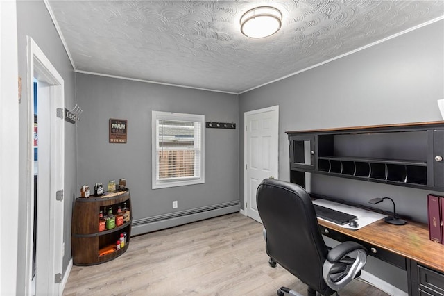 office area featuring baseboard heating, light wood-style flooring, a textured ceiling, and ornamental molding