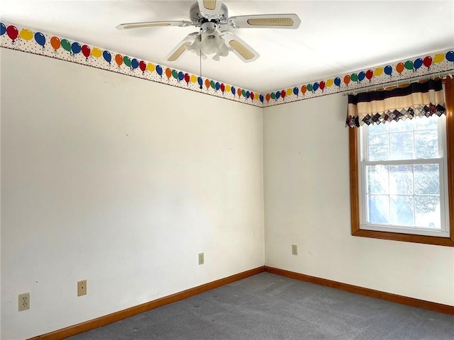 spare room featuring carpet, baseboards, and ceiling fan