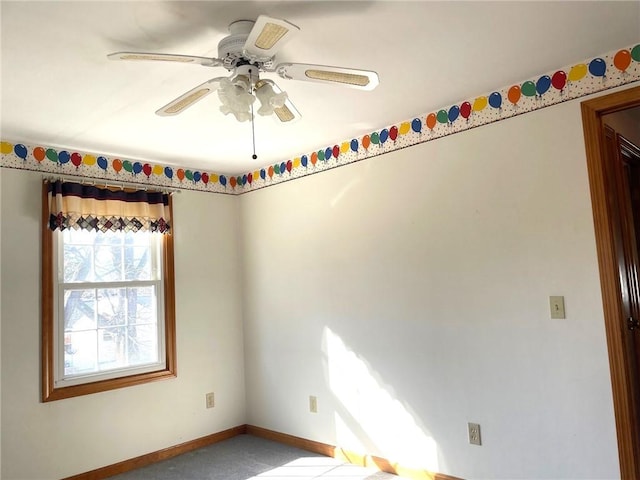 unfurnished room featuring baseboards and ceiling fan