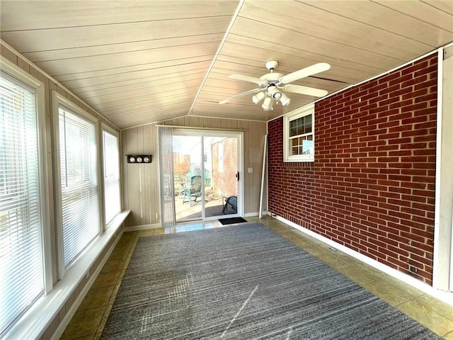 unfurnished sunroom featuring lofted ceiling, wooden ceiling, and a ceiling fan