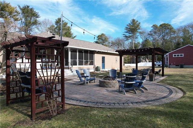 view of patio featuring a fire pit, a sunroom, and a pergola