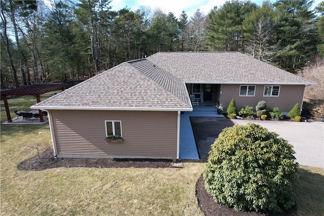 single story home with a front yard and roof with shingles